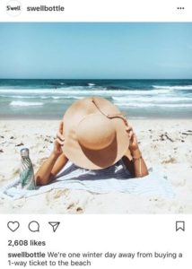 screenshot of s'well bottle isntagram post featuring woman laying on beach