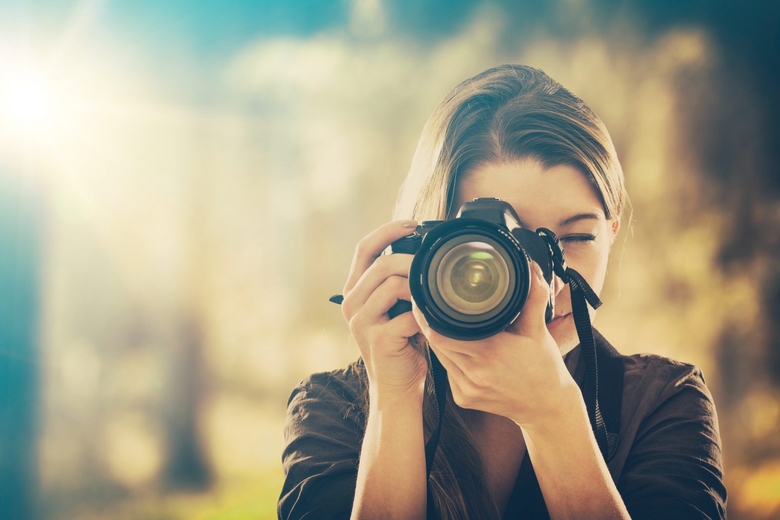 a stock image of a woman taking picture with camera